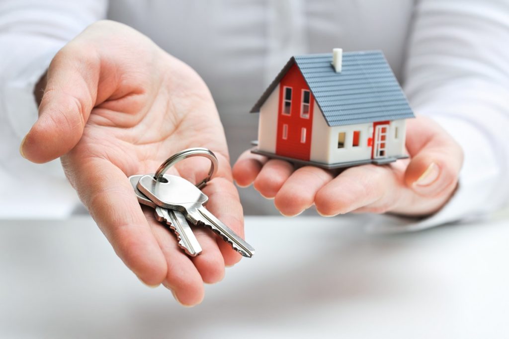real estate broker holding a house key