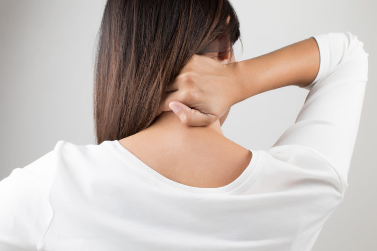 Young woman having pain in the back and neck,Pain in the back