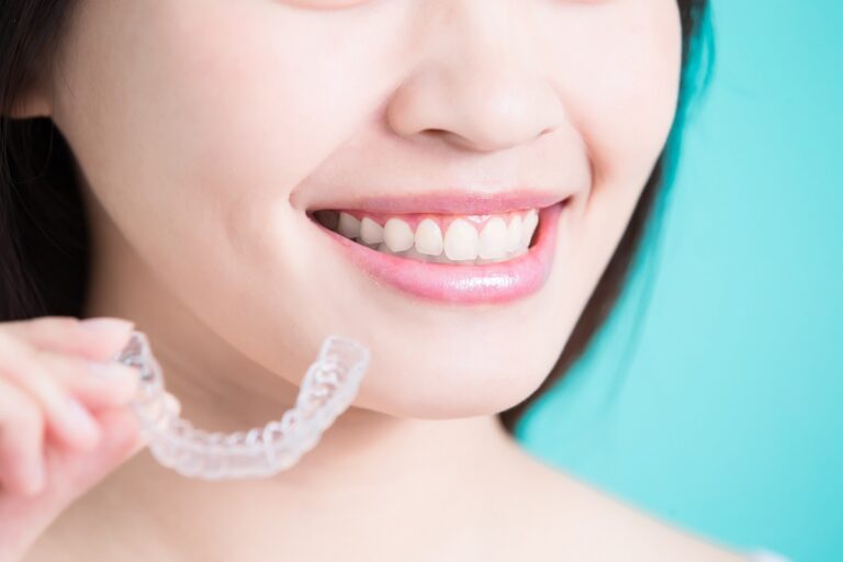 beautiful smile of a woman holding invisible braces